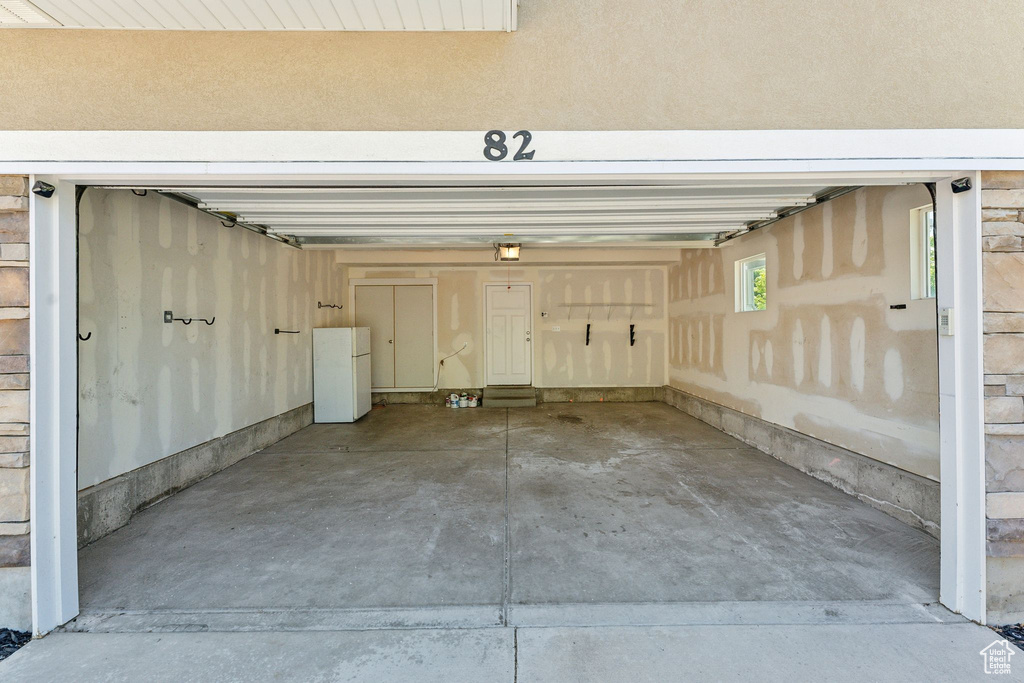 Garage featuring freestanding refrigerator