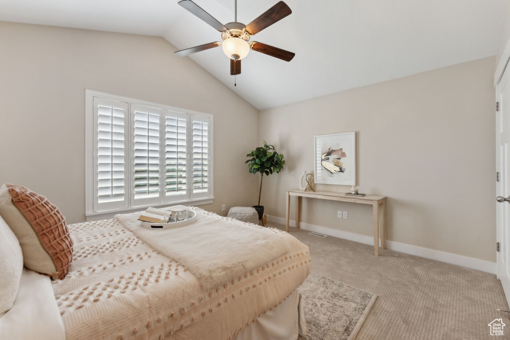 Bedroom with lofted ceiling, carpet, baseboards, and ceiling fan