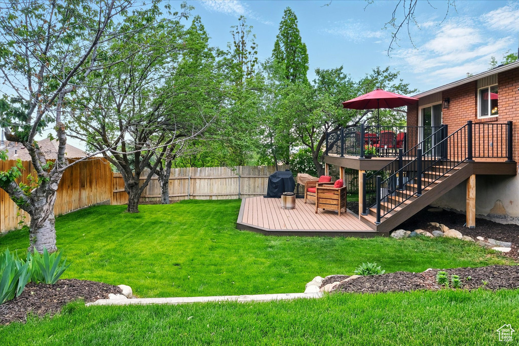 View of yard featuring a deck and stairway