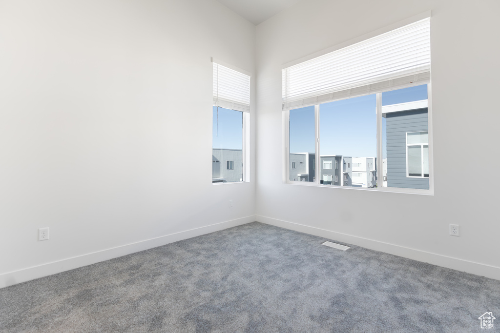 Carpeted empty room with baseboards
