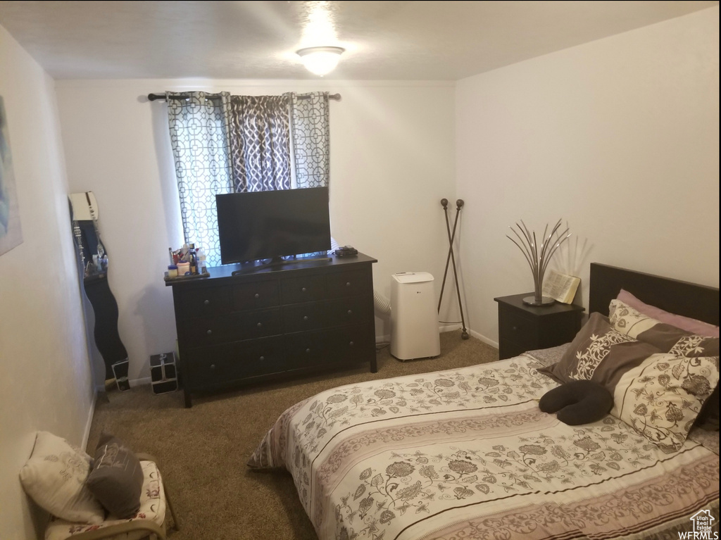 Carpeted bedroom featuring baseboards