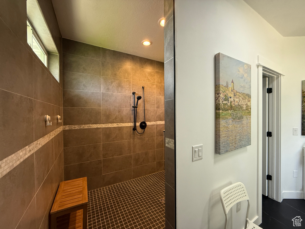 Full bath featuring a walk in shower, recessed lighting, tile patterned flooring, and baseboards