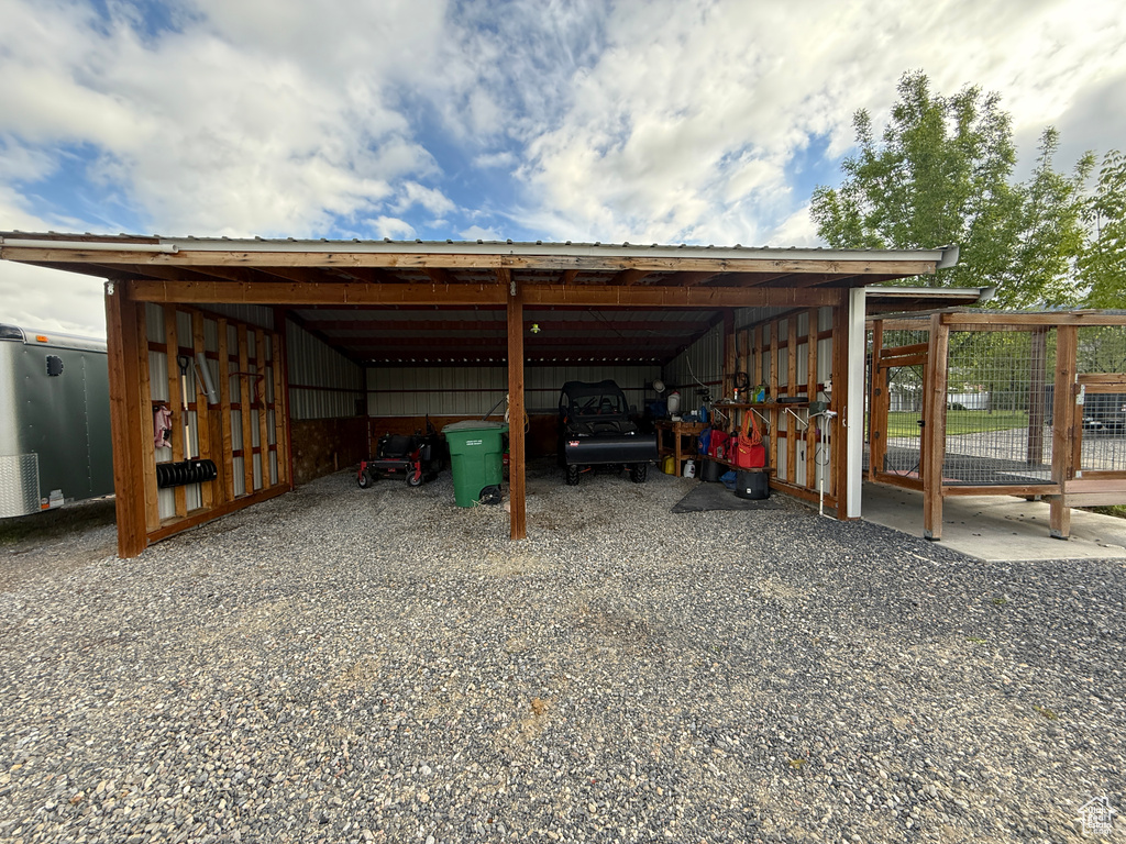 View of parking featuring an outbuilding