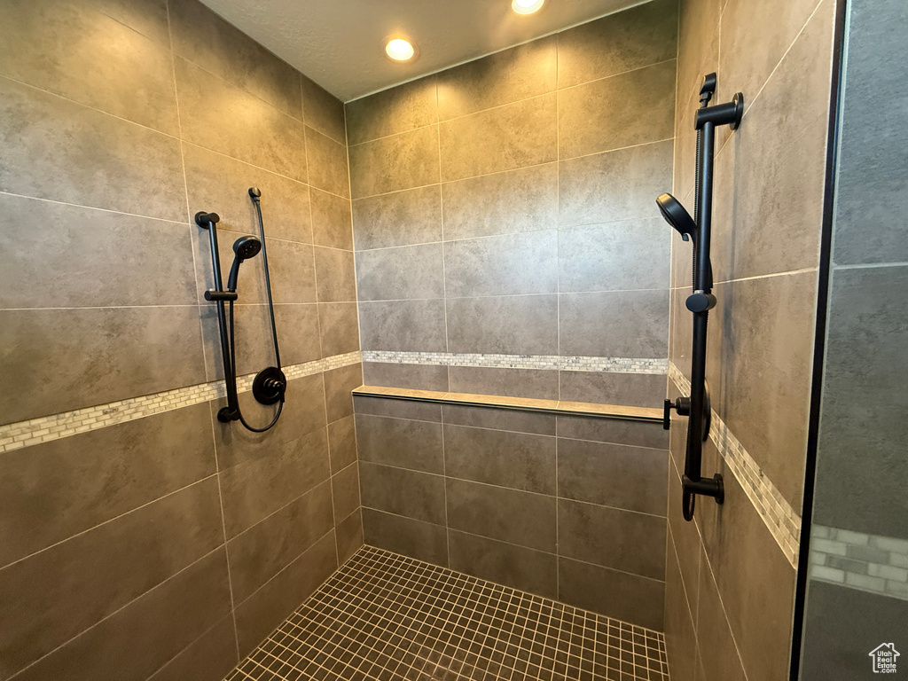 Bathroom with a tile shower and recessed lighting
