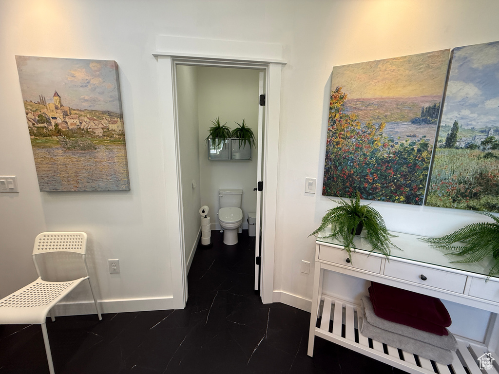 Bathroom featuring baseboards and toilet