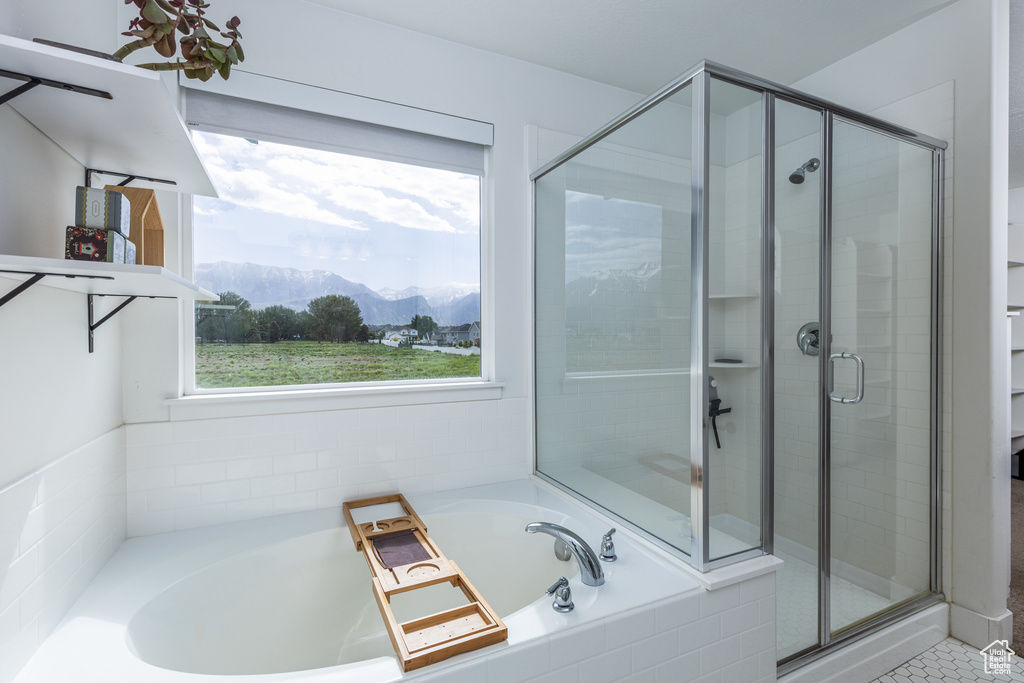 Full bathroom with a mountain view, a stall shower, and a garden tub