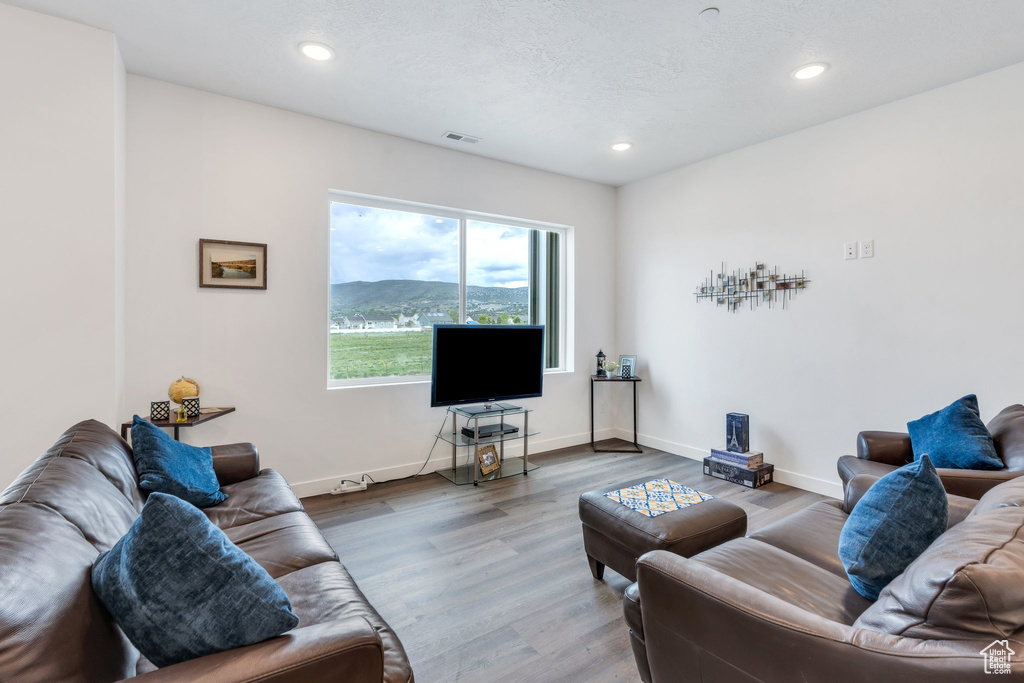 Living room featuring recessed lighting, wood finished floors, and baseboards