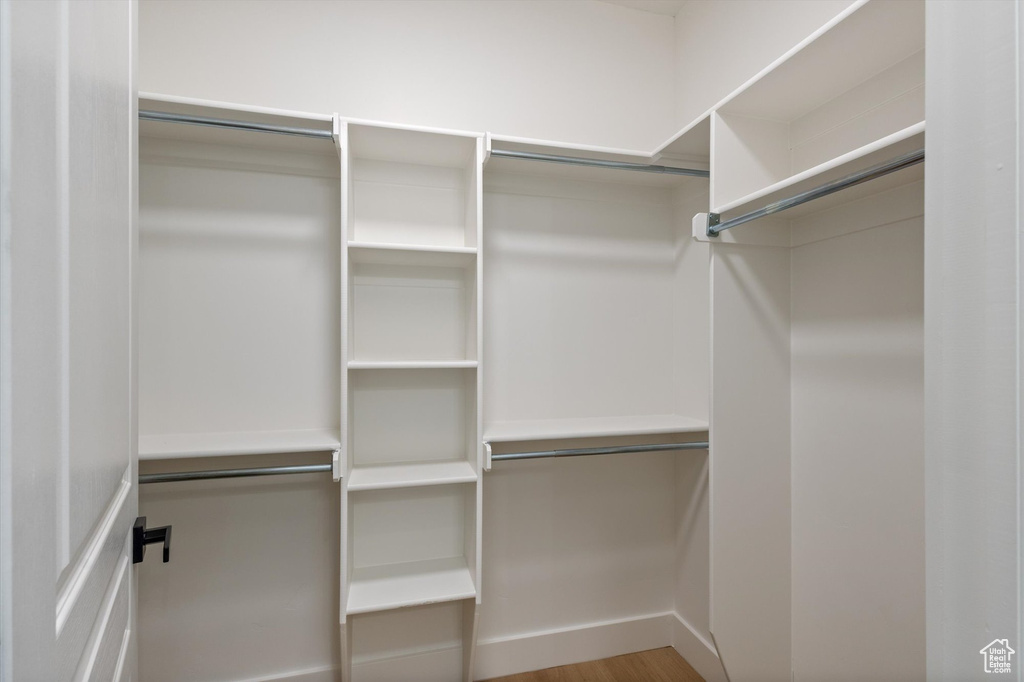 Walk in closet featuring wood finished floors