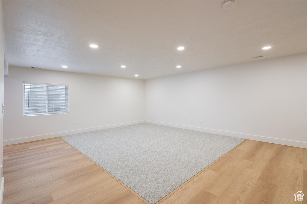 Spare room with recessed lighting, light wood-style flooring, a smoke detector, and baseboards