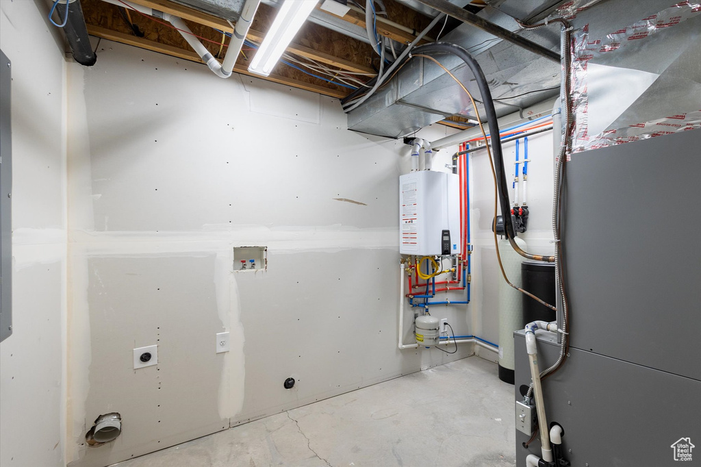 Utility room with tankless water heater and heating unit