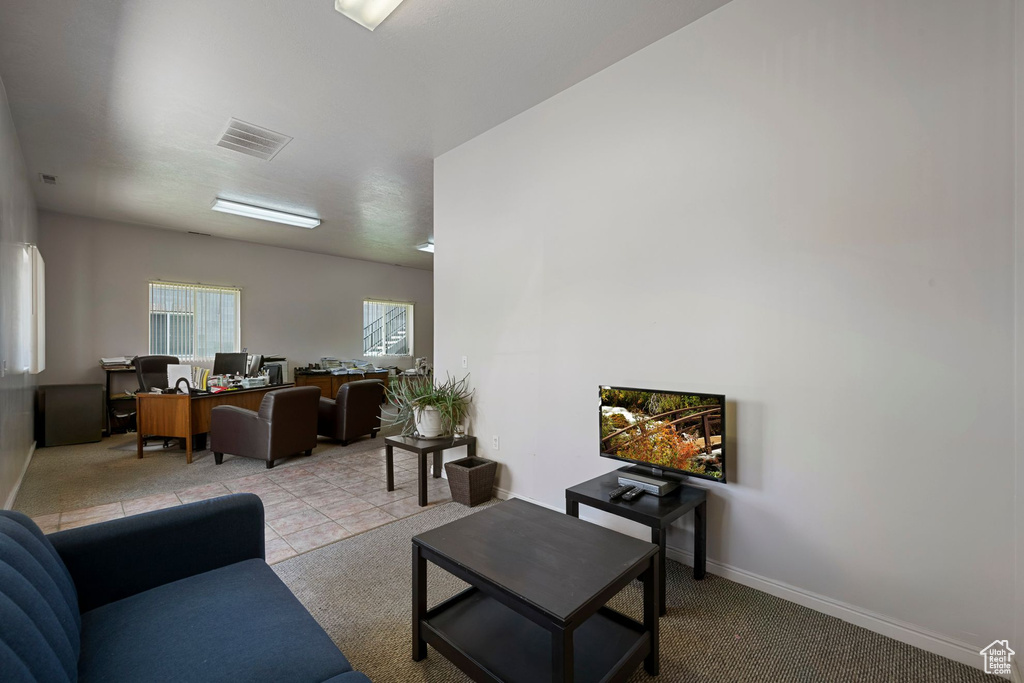 Living area featuring an office area and baseboards