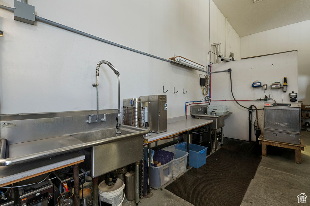 Kitchen with concrete floors and white cabinets