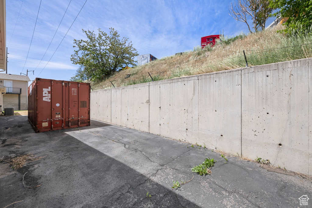 View of patio featuring fence, mail area, and central air condition unit