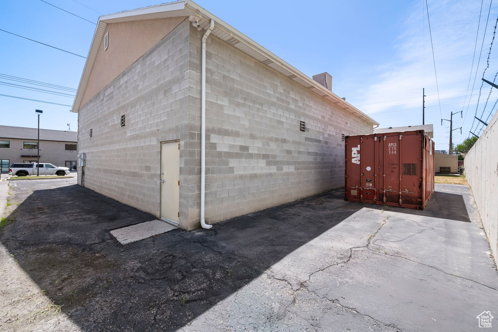 View of side of home featuring concrete block siding