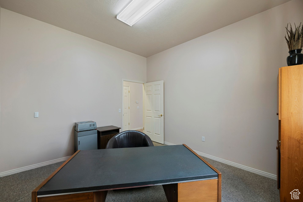 Carpeted home office with baseboards