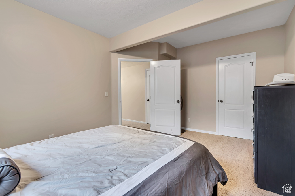 Bedroom featuring carpet flooring and baseboards