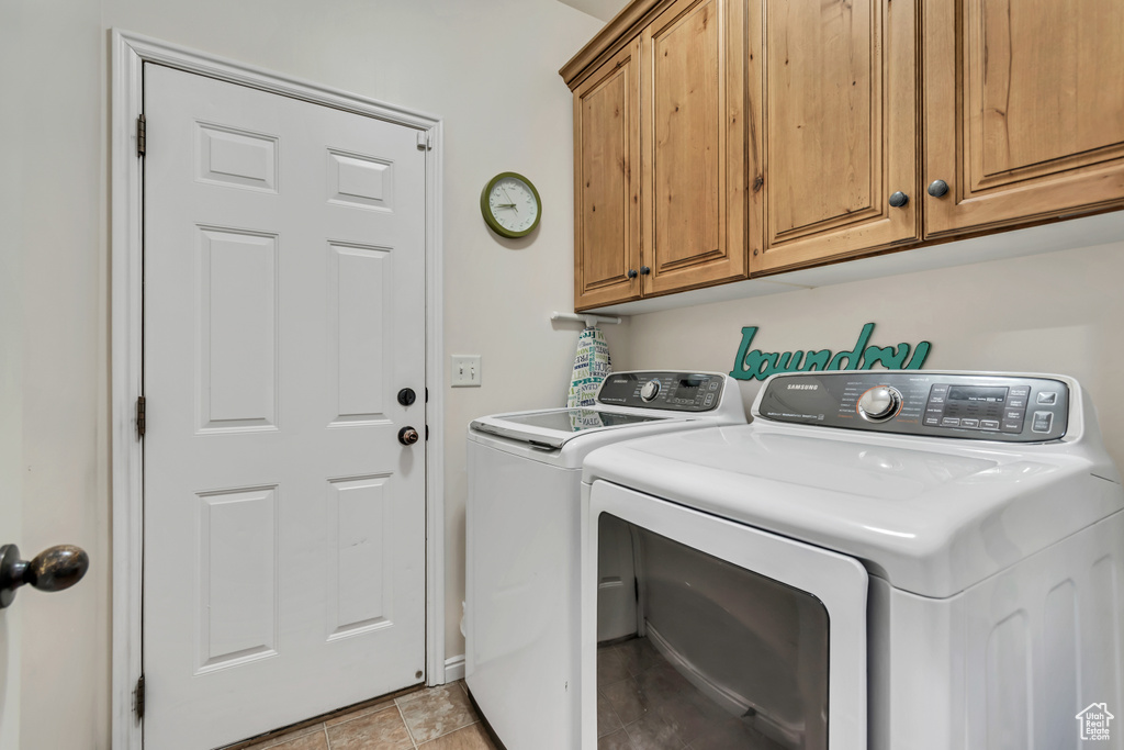 Laundry area featuring washer and dryer and cabinet space