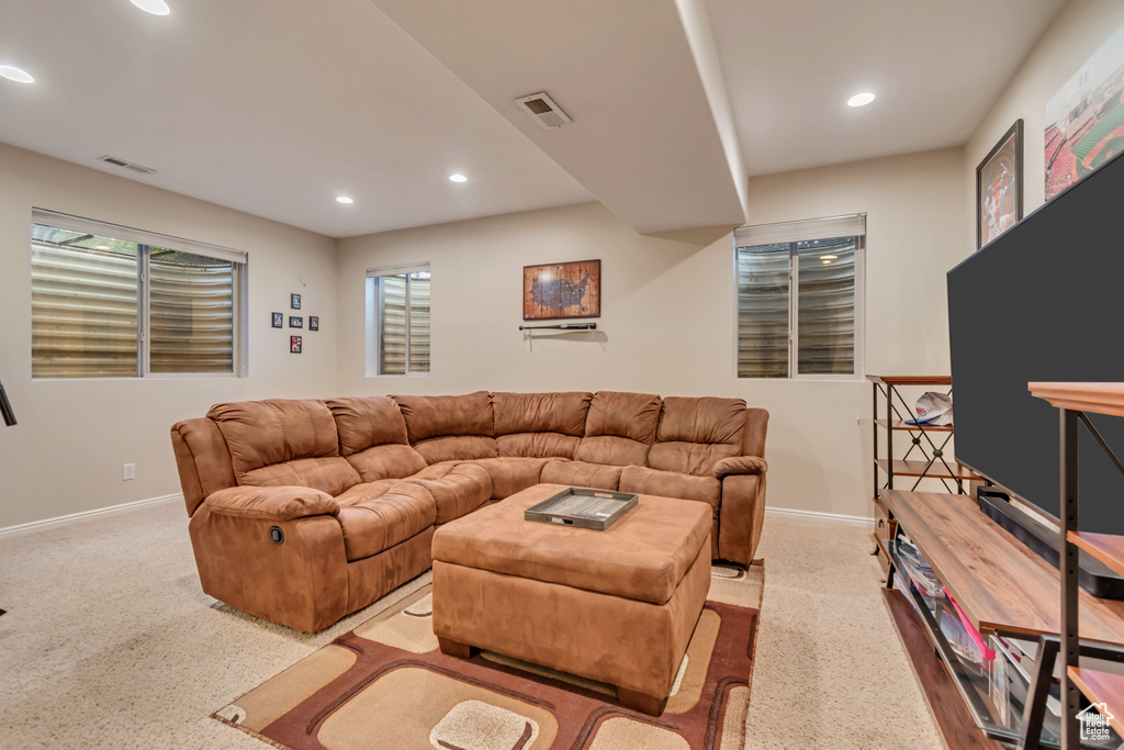 Living area with recessed lighting, carpet flooring, baseboards, and healthy amount of natural light