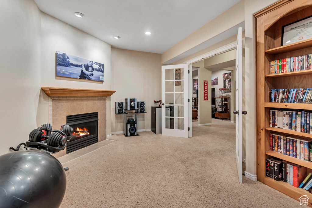 Sitting room with french doors, carpet, a tile fireplace, recessed lighting, and baseboards