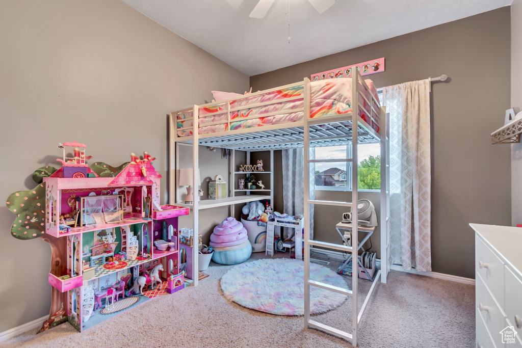 Bedroom featuring carpet, ceiling fan, baseboards, and lofted ceiling
