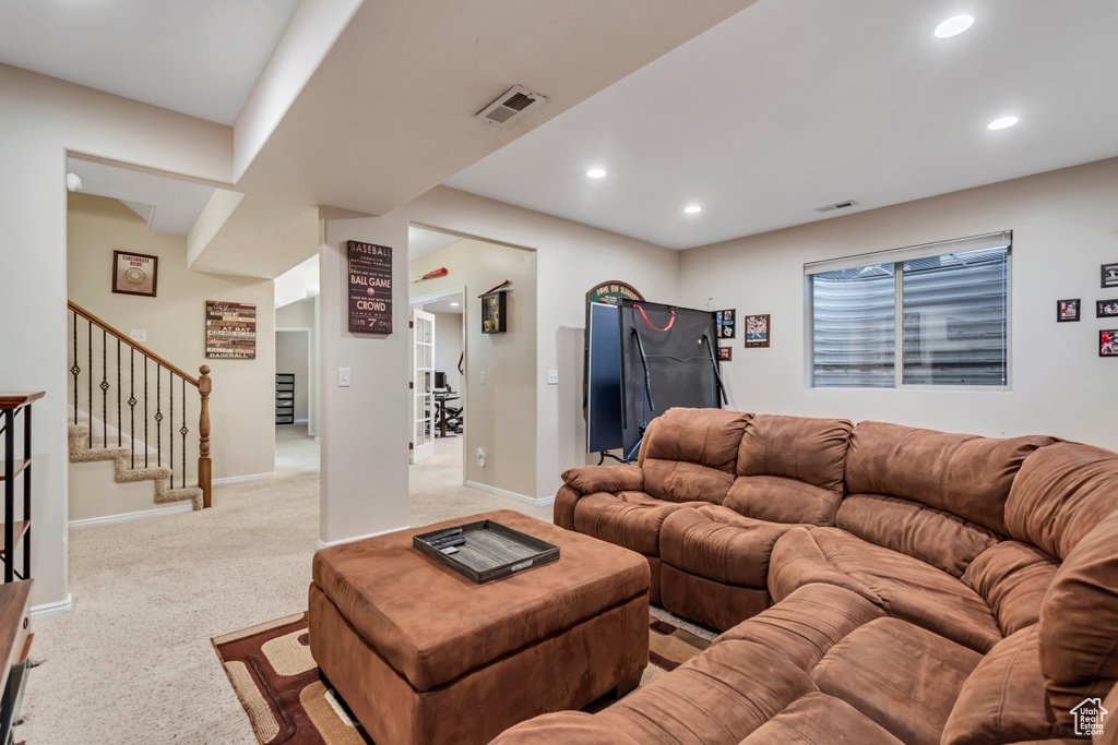 Living area featuring stairway, recessed lighting, baseboards, and light colored carpet
