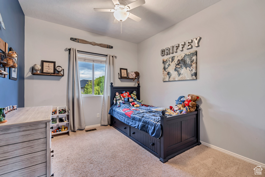 Bedroom with carpet flooring, baseboards, and ceiling fan
