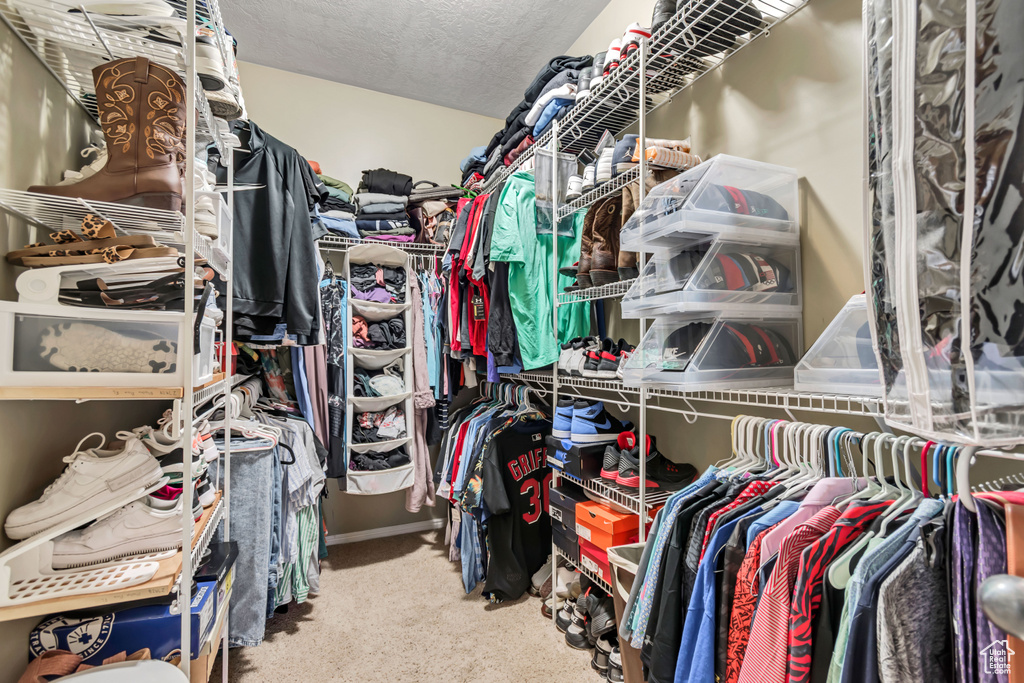 Walk in closet featuring carpet flooring