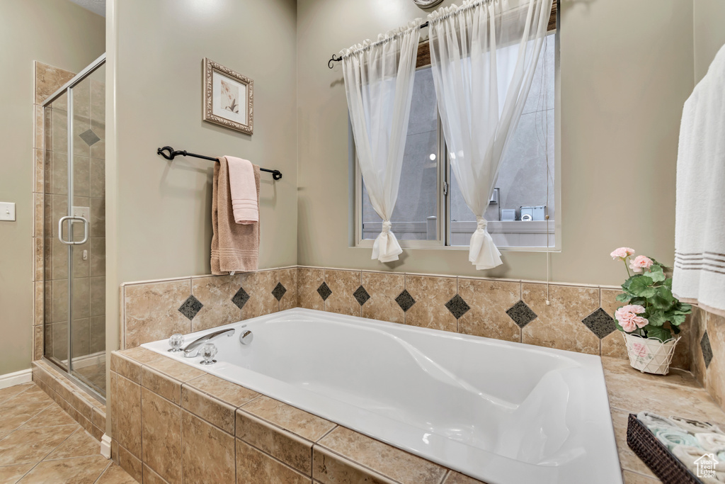 Bathroom with a shower stall and a bath