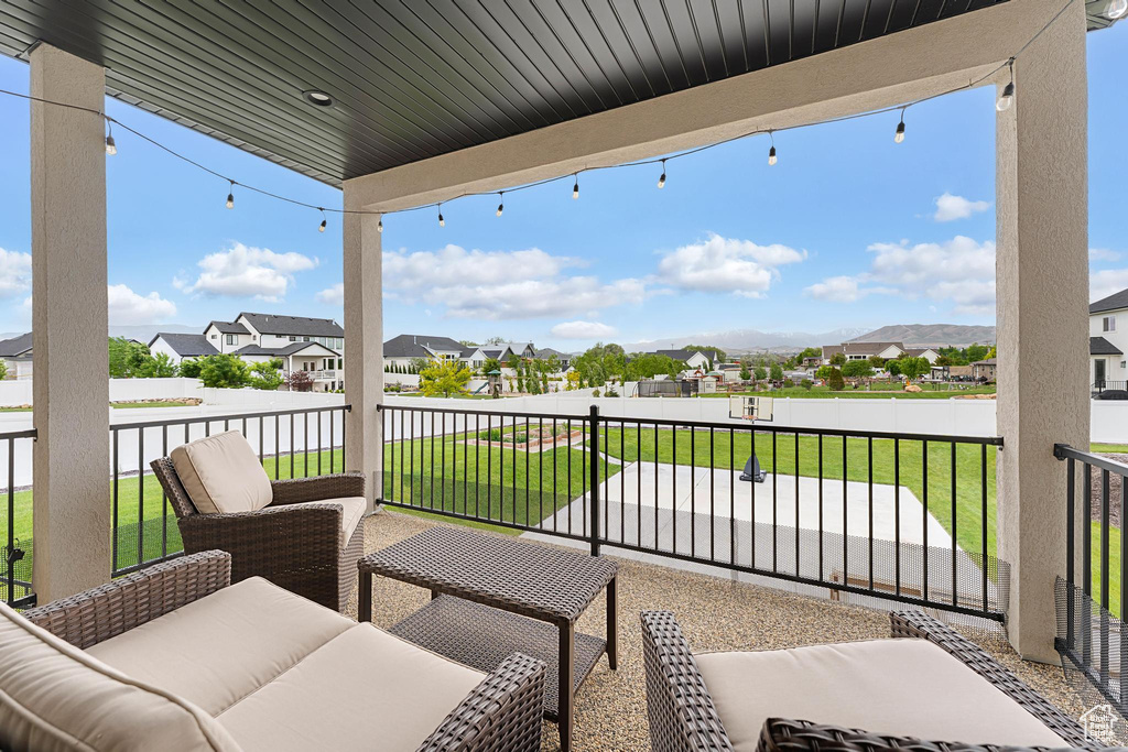View of patio featuring a residential view, a balcony, and an outdoor hangout area