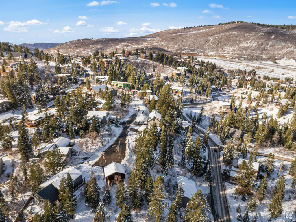 Snowy aerial view with a mountain view and a residential view