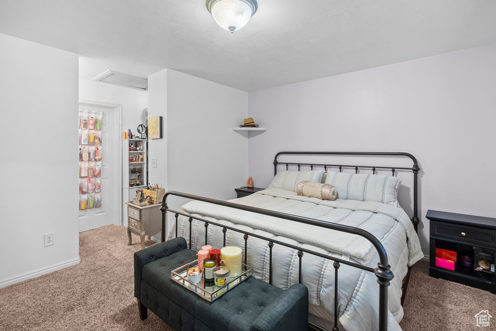 Bedroom featuring carpet flooring, attic access, and baseboards