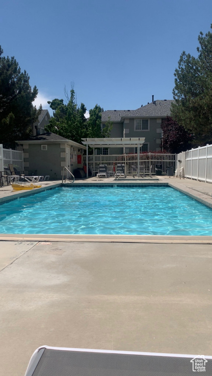 Community pool with a patio