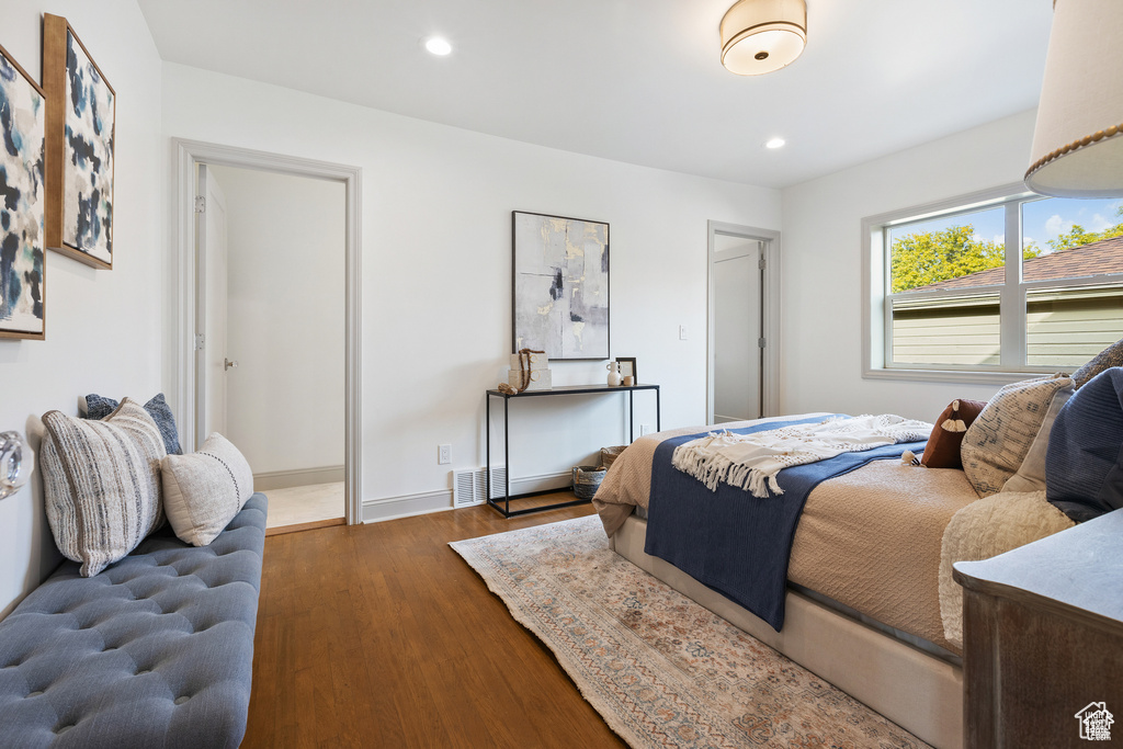 Bedroom with wood finished floors, recessed lighting, and baseboards