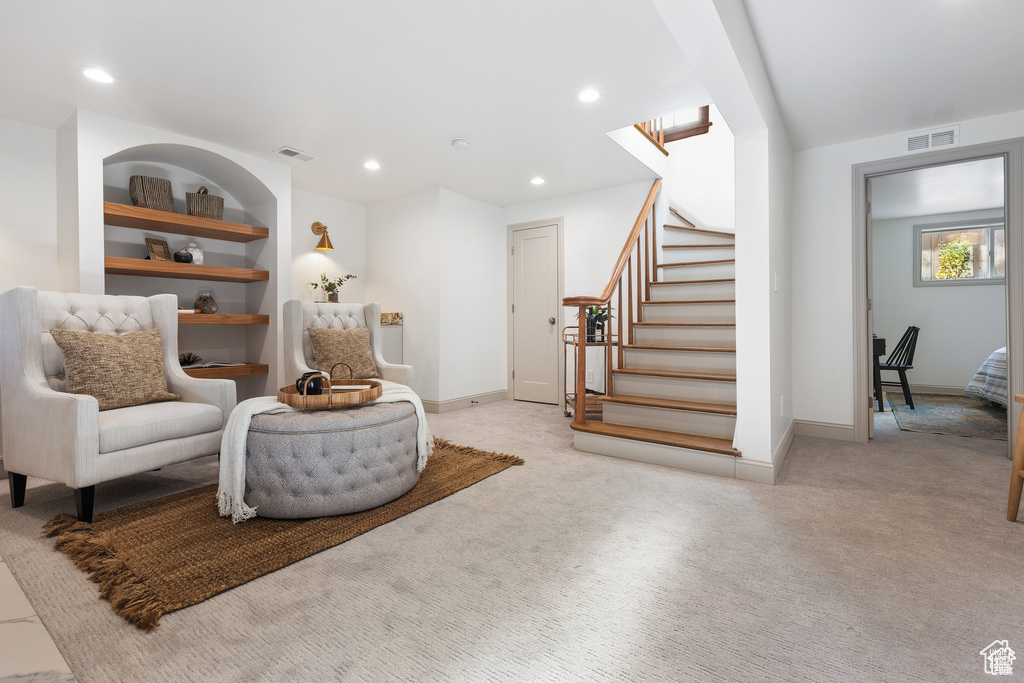 Living area featuring carpet flooring, stairway, baseboards, and recessed lighting