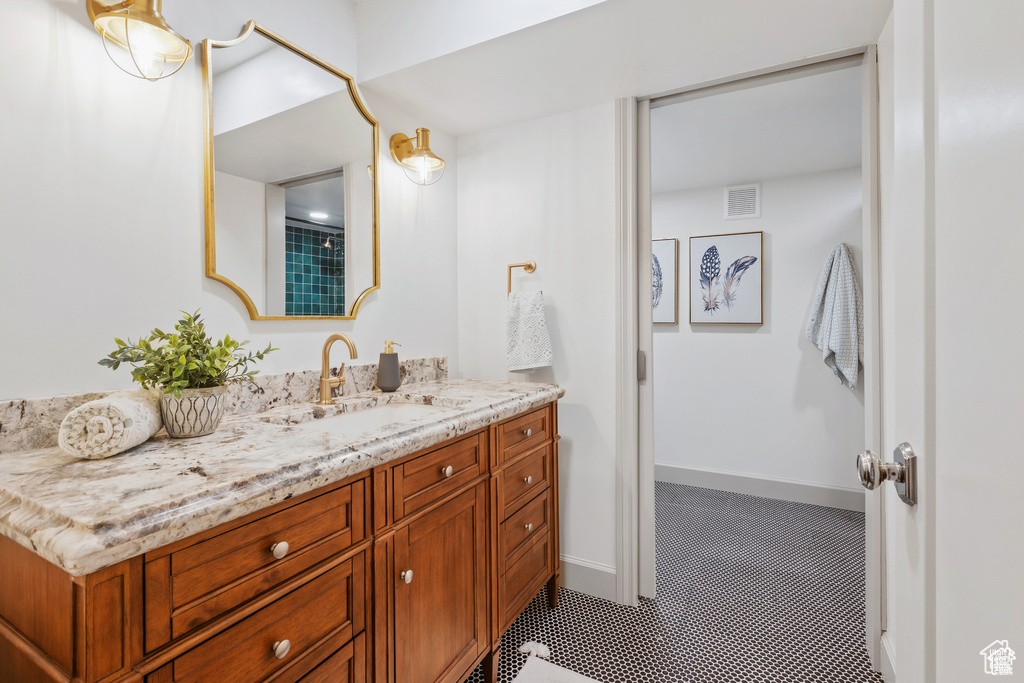 Full bathroom with vanity and tile patterned floors