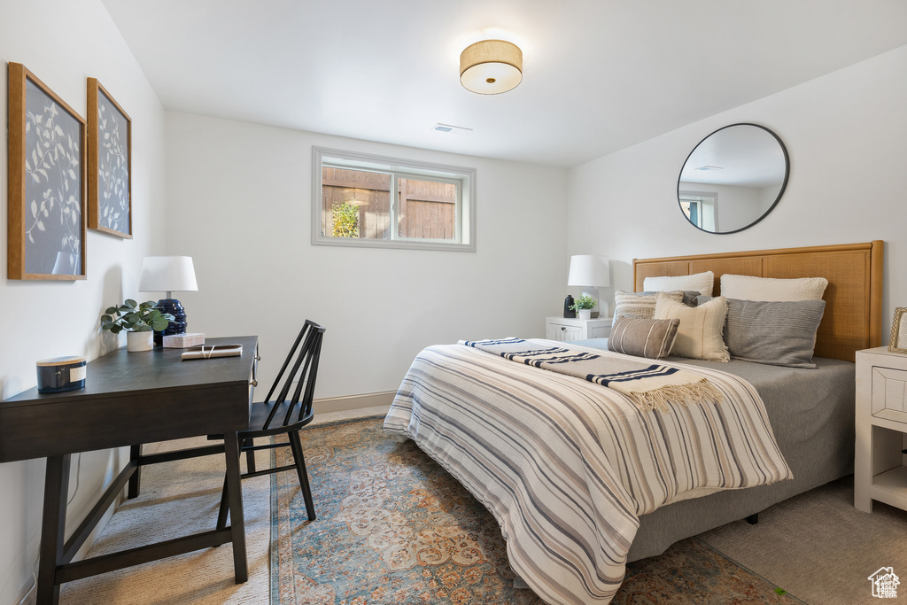 Bedroom with an office area and baseboards