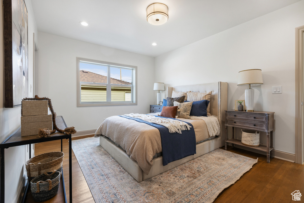 Bedroom with baseboards, wood finished floors, and recessed lighting