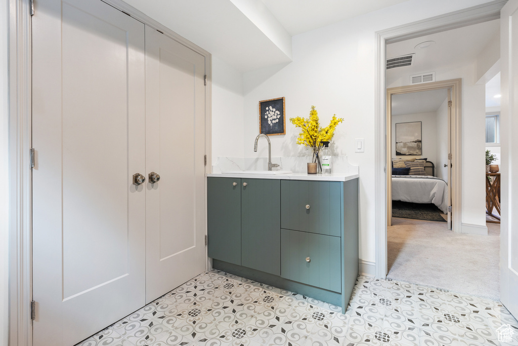 Bathroom featuring tile patterned floors, vanity, and ensuite bathroom