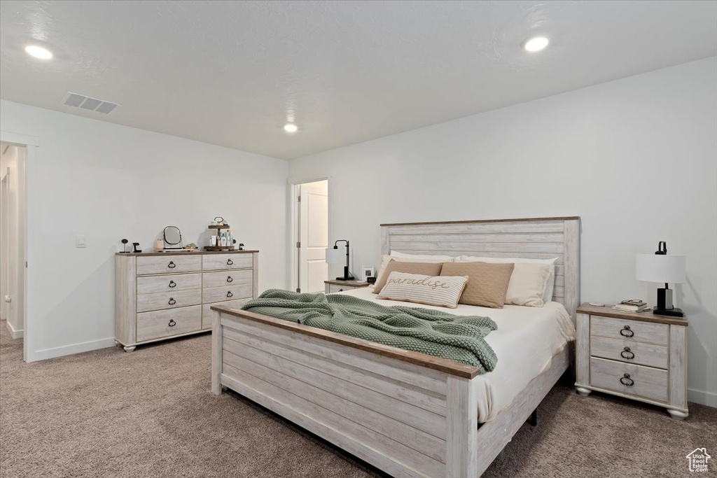 Carpeted bedroom with recessed lighting and baseboards