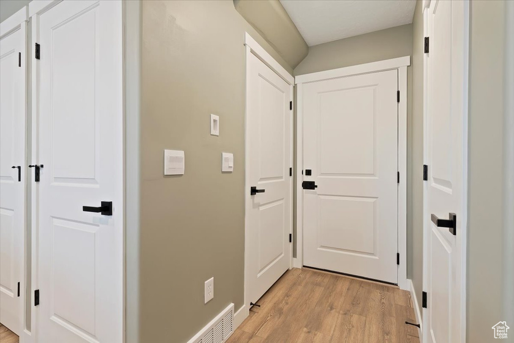 Hall with light wood-style floors and baseboards