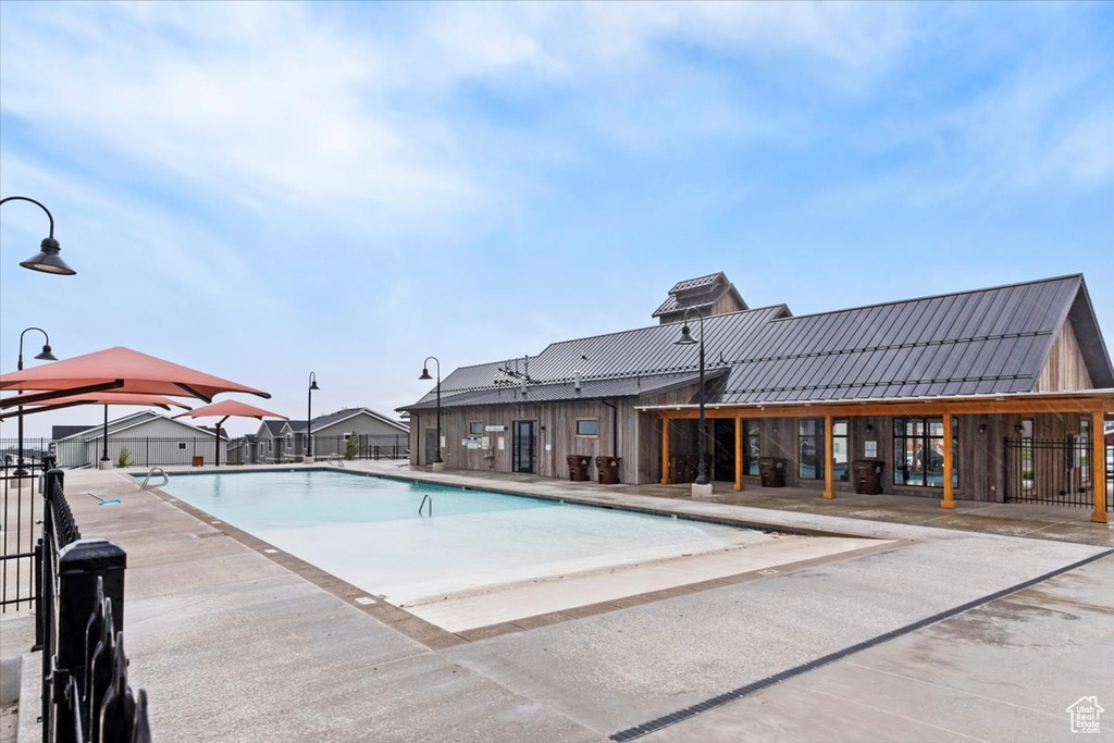 Community pool with fence and a patio