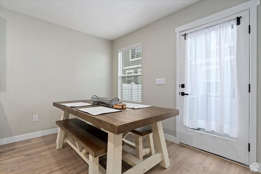 Dining area with baseboards and light wood finished floors