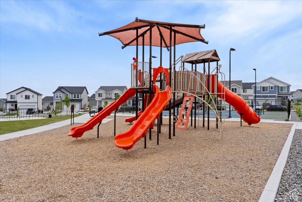 Community play area featuring a residential view and fence