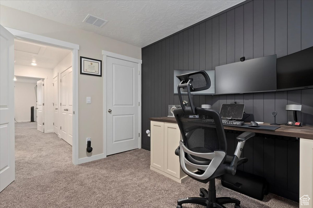 Office space with light carpet and baseboards