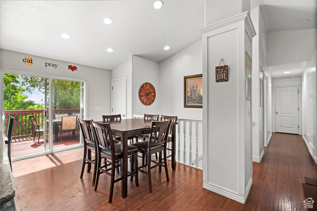 Dining room featuring hardwood / wood-style floors, recessed lighting, vaulted ceiling, and baseboards
