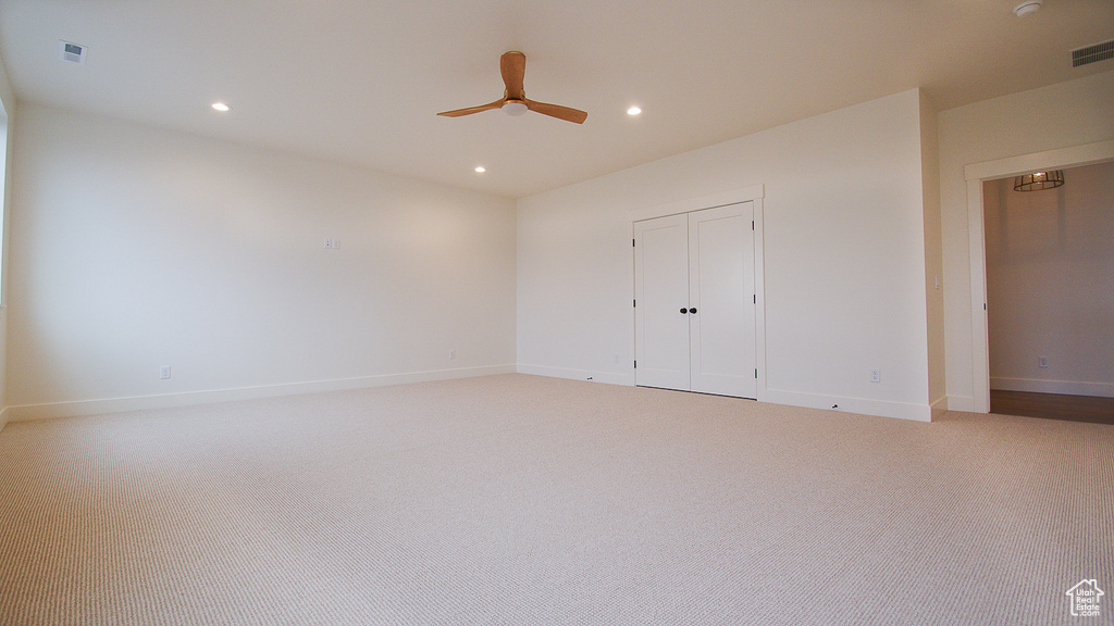 Unfurnished bedroom featuring light colored carpet, baseboards, recessed lighting, a closet, and a ceiling fan