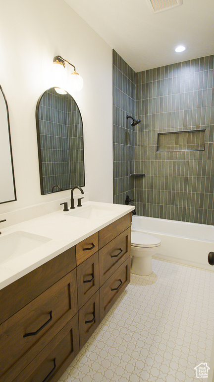 Full bath featuring double vanity, toilet, bathing tub / shower combination, and recessed lighting