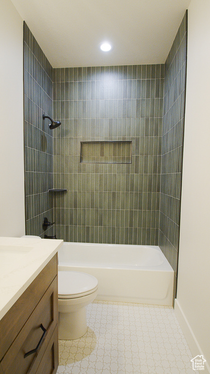 Full bathroom featuring shower / bath combination, toilet, recessed lighting, vanity, and baseboards