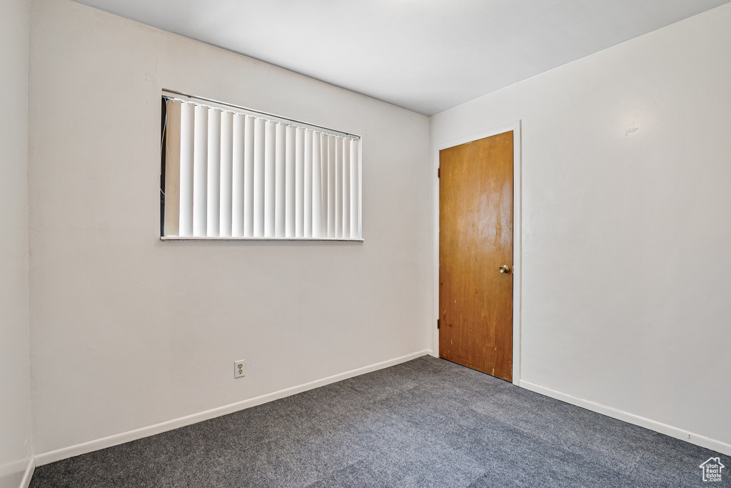 Carpeted spare room with baseboards