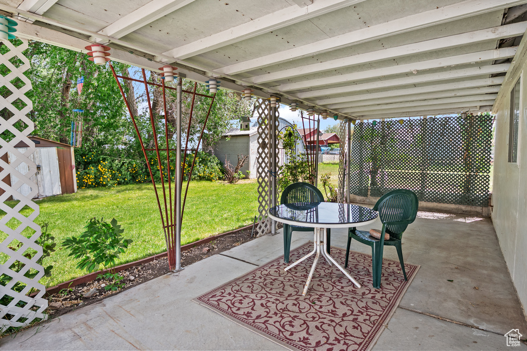 View of patio / terrace with a shed and an outdoor structure